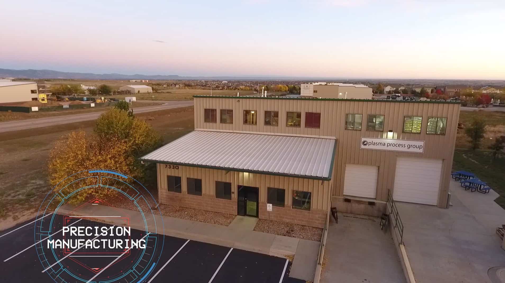 A metal building with loading docks and a front entrance. This is a 2 story metal building with a parking lot. This is our manufacturing facility in Windsor Colorado.