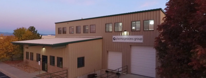 A metal building with loading docks and a front entrance. This is a 2 story metal building with a parking lot. This is our manufacturing facility in Windsor Colorado.