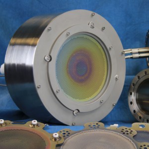 A round cylinder houses the ion beam source and multi aperture grid assembly produces the 16 cm ion beam.