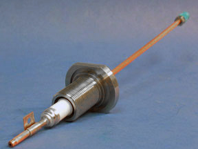 This is an image of a single 32mm RF Feedthrough made of copper tubing, steel, and a ceramic electrical insulator.