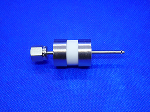 This is an image of a gas isolator with a connecting nut on one end and a 1-inch outlet tube on the other end.